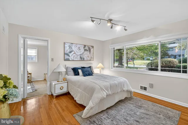 a bedroom with a bed and a large window