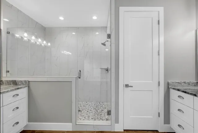 a bathroom with a shower sink and mirror