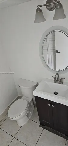 a bathroom with a sink mirror and toilet