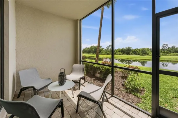 a view of a chairs and table in a balcony