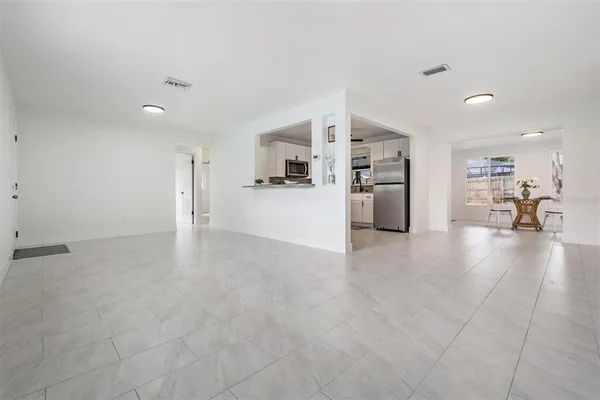 a view of a living room and kitchen with furniture and a stove