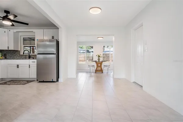 a kitchen with stainless steel appliances granite countertop a refrigerator a stove top oven a sink and dishwasher