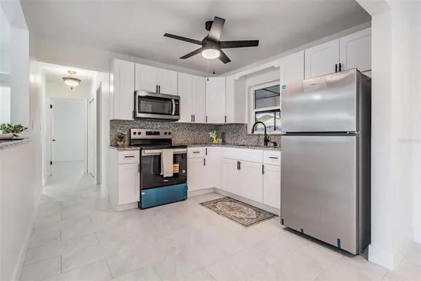a kitchen with a sink stove and microwave