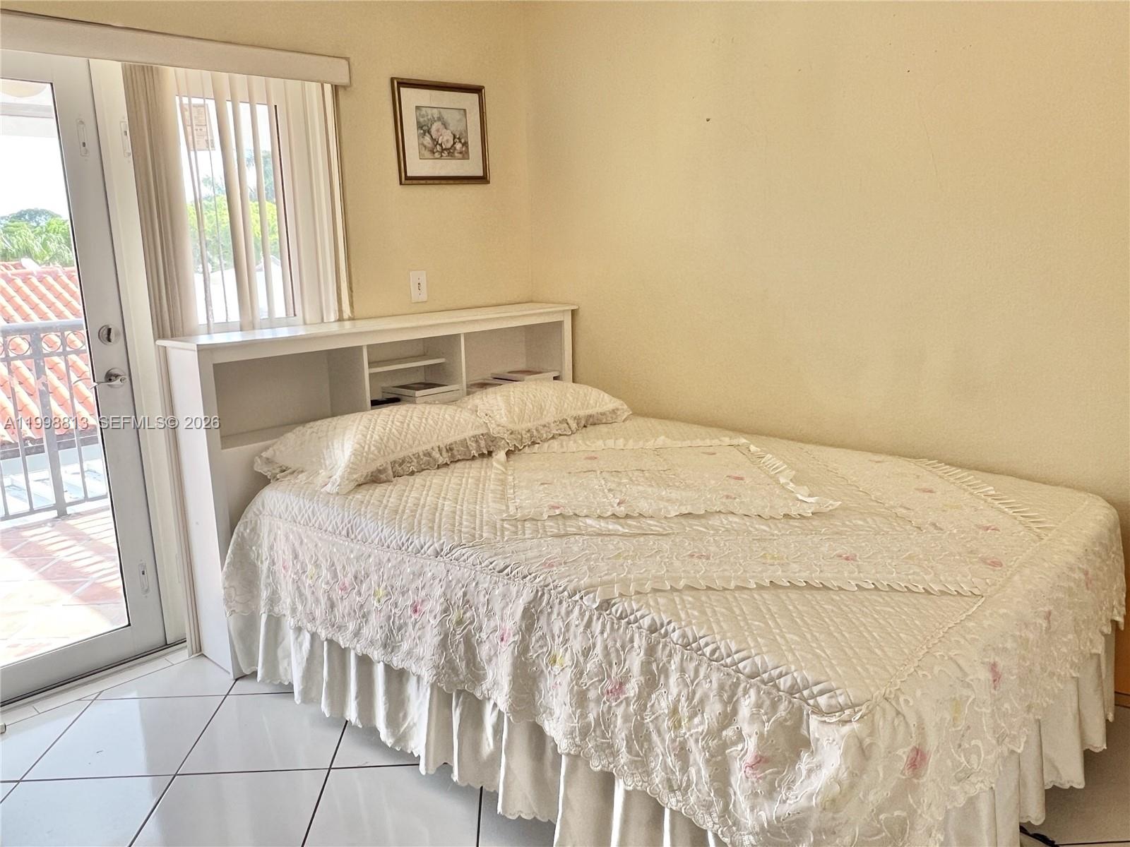 10140 Southwest 26th Terrace Miami, FL 33165 - Photo 15 of 70 a large bed sitting in a bedroom next to a window
