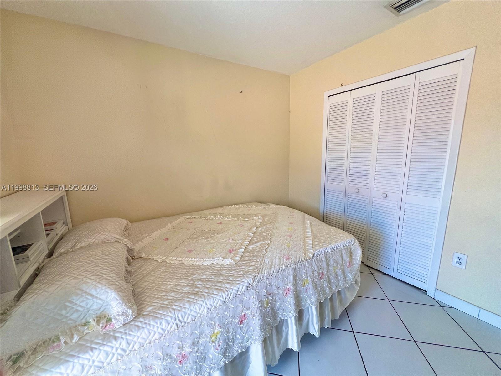 10140 Southwest 26th Terrace Miami, FL 33165 - Photo 16 of 70 a bedroom with a bed and a window