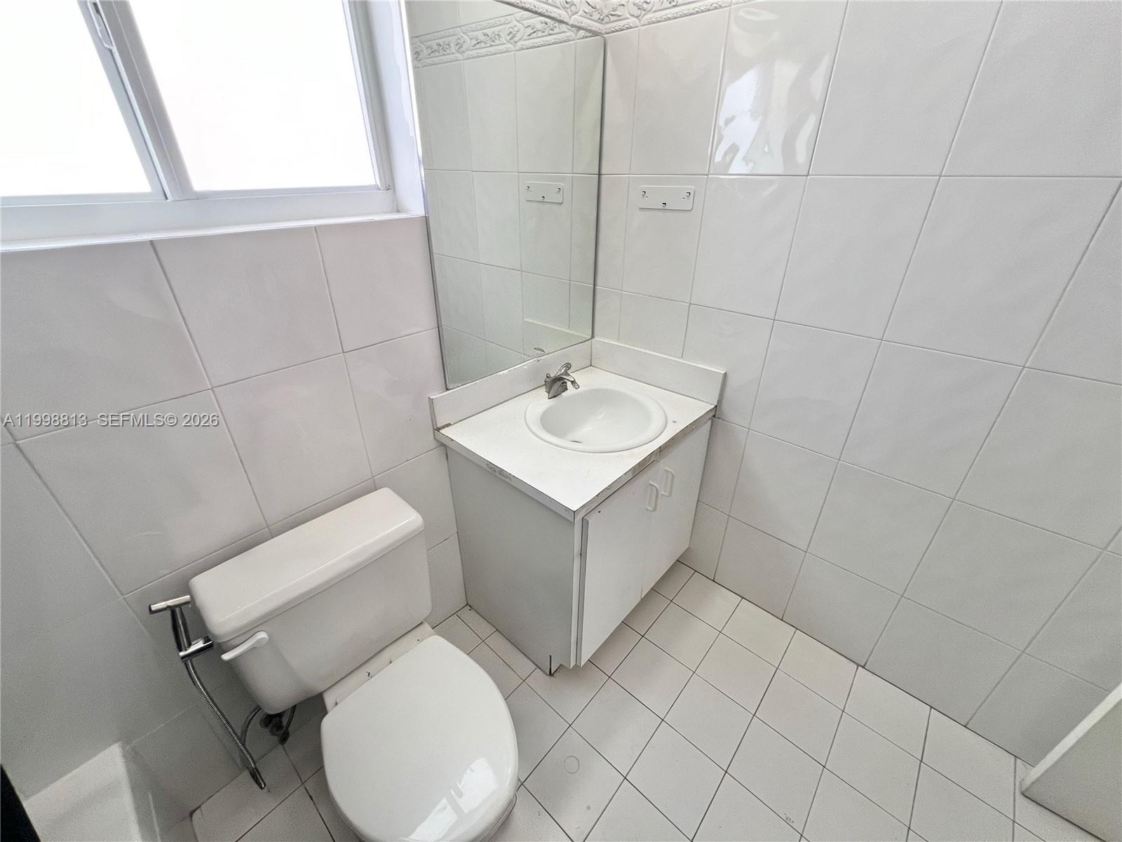 10140 Southwest 26th Terrace Miami, FL 33165 - Photo 24 of 70 a bathroom with a sink toilet and mirror