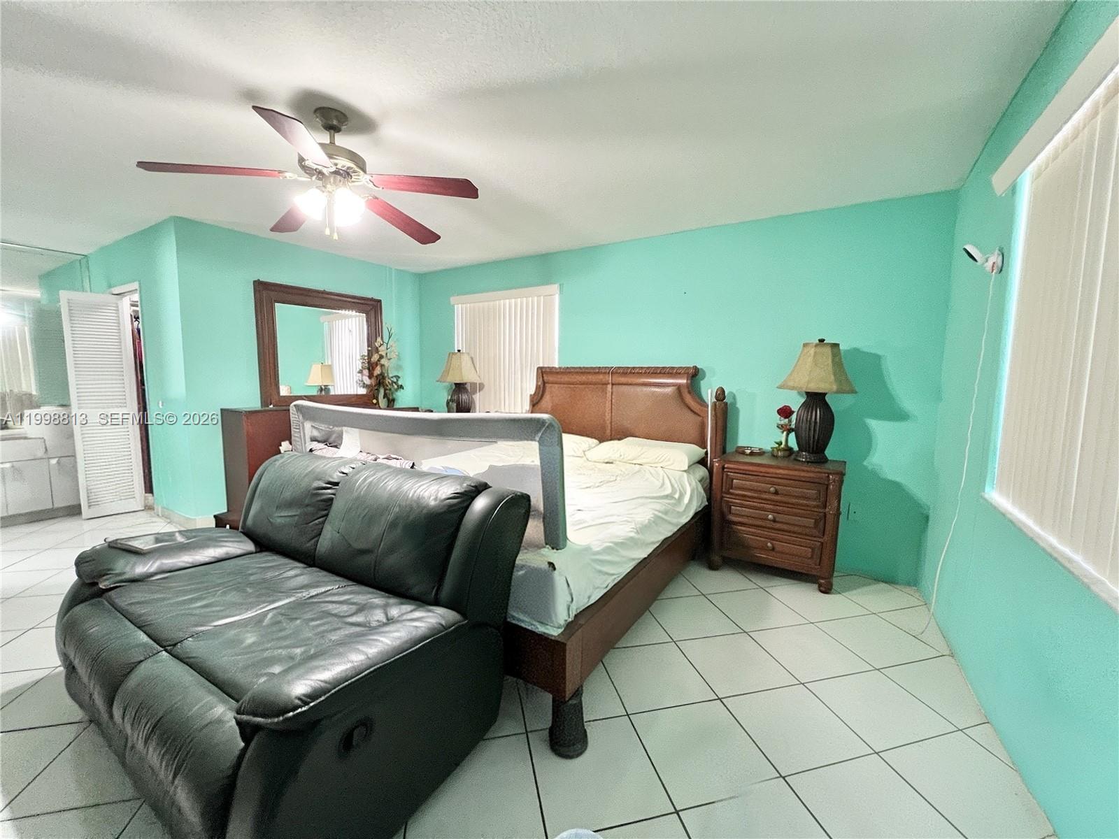 10140 Southwest 26th Terrace Miami, FL 33165 - Photo 25 of 70 a bedroom with a bed and a chandelier