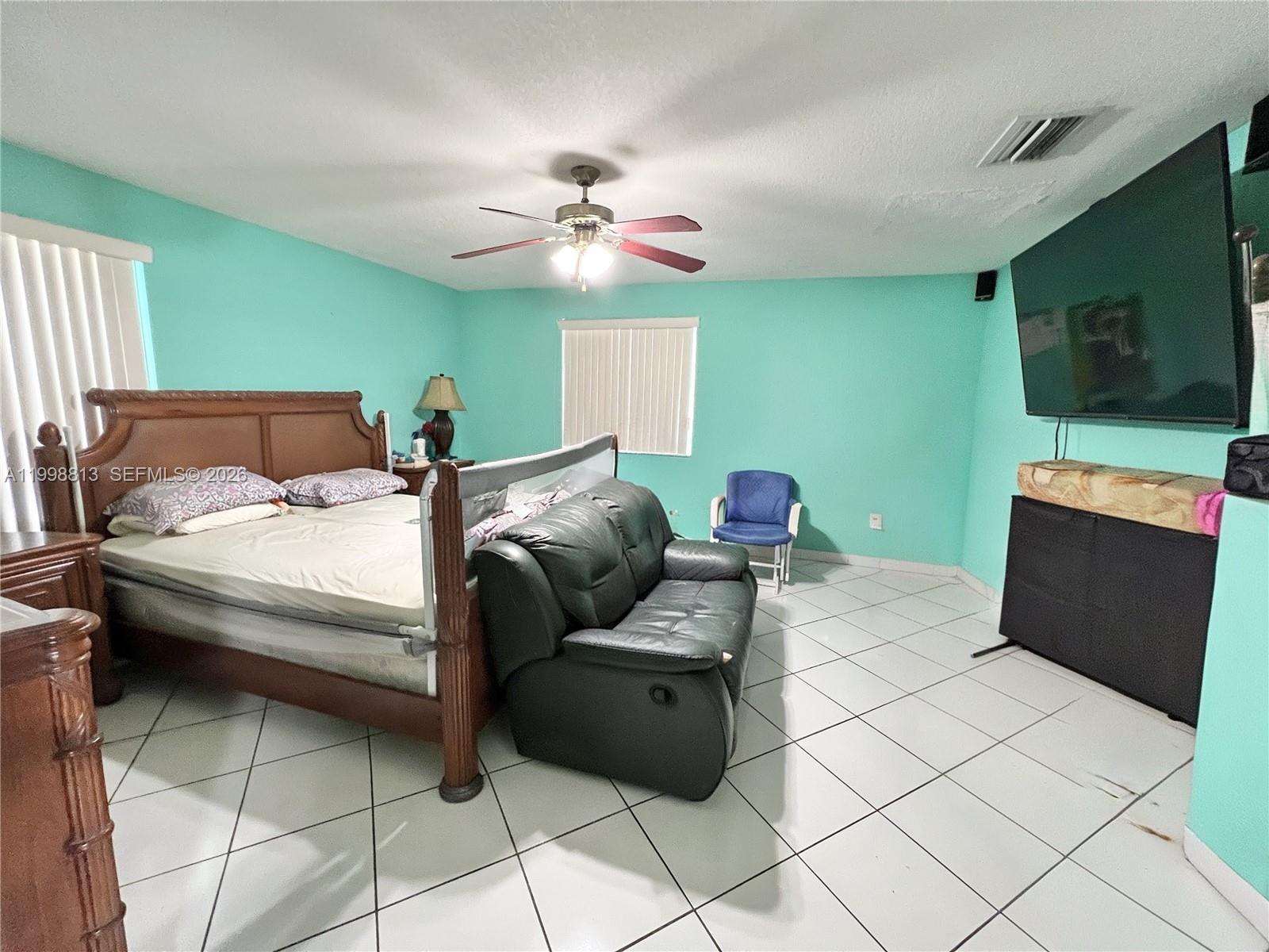 10140 Southwest 26th Terrace Miami, FL 33165 - Photo 26 of 70 a bedroom with a bed and a flat screen tv