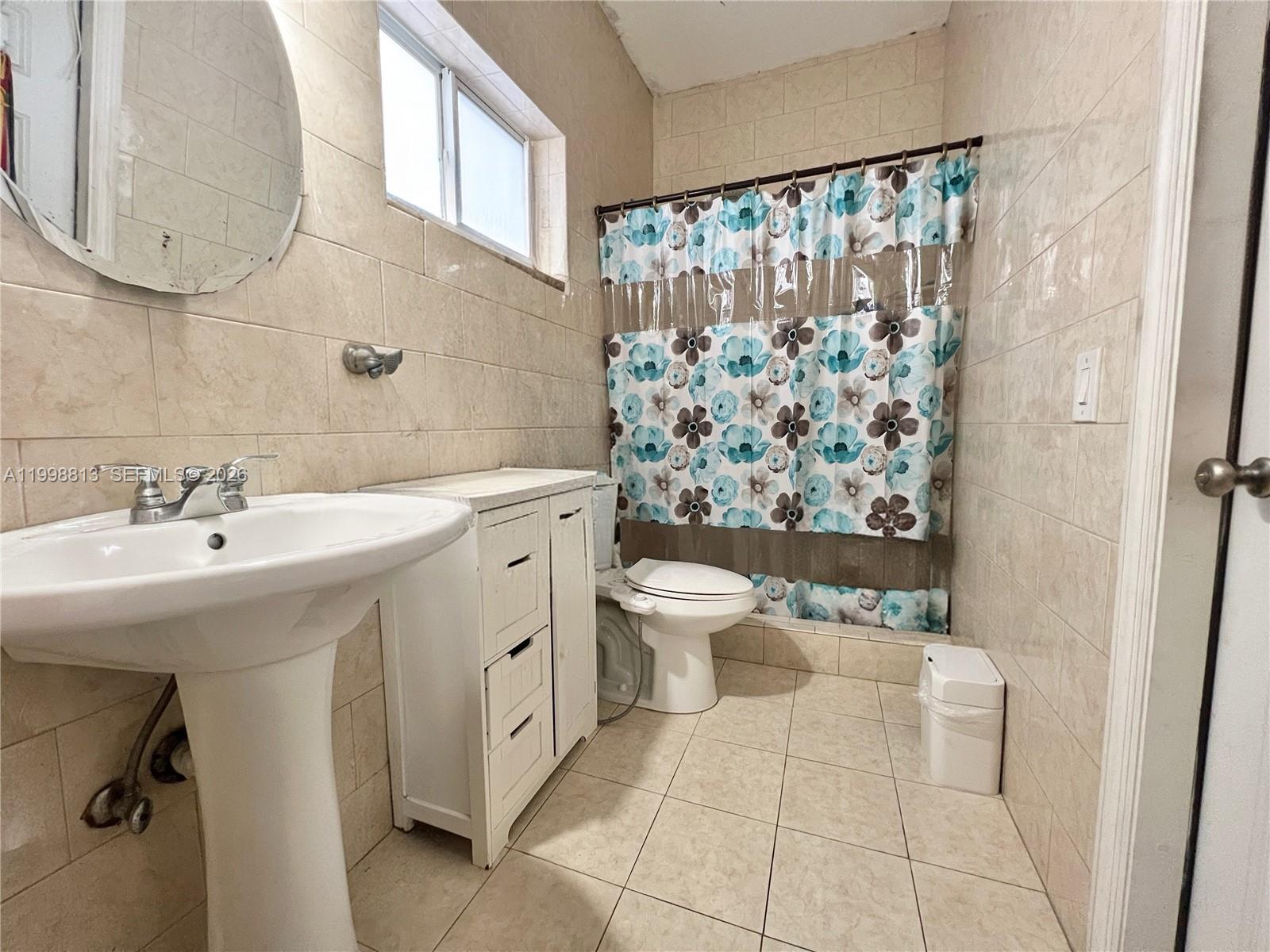 10140 Southwest 26th Terrace Miami, FL 33165 - Photo 30 of 70 a bathroom with a sink a toilet and shower curtain