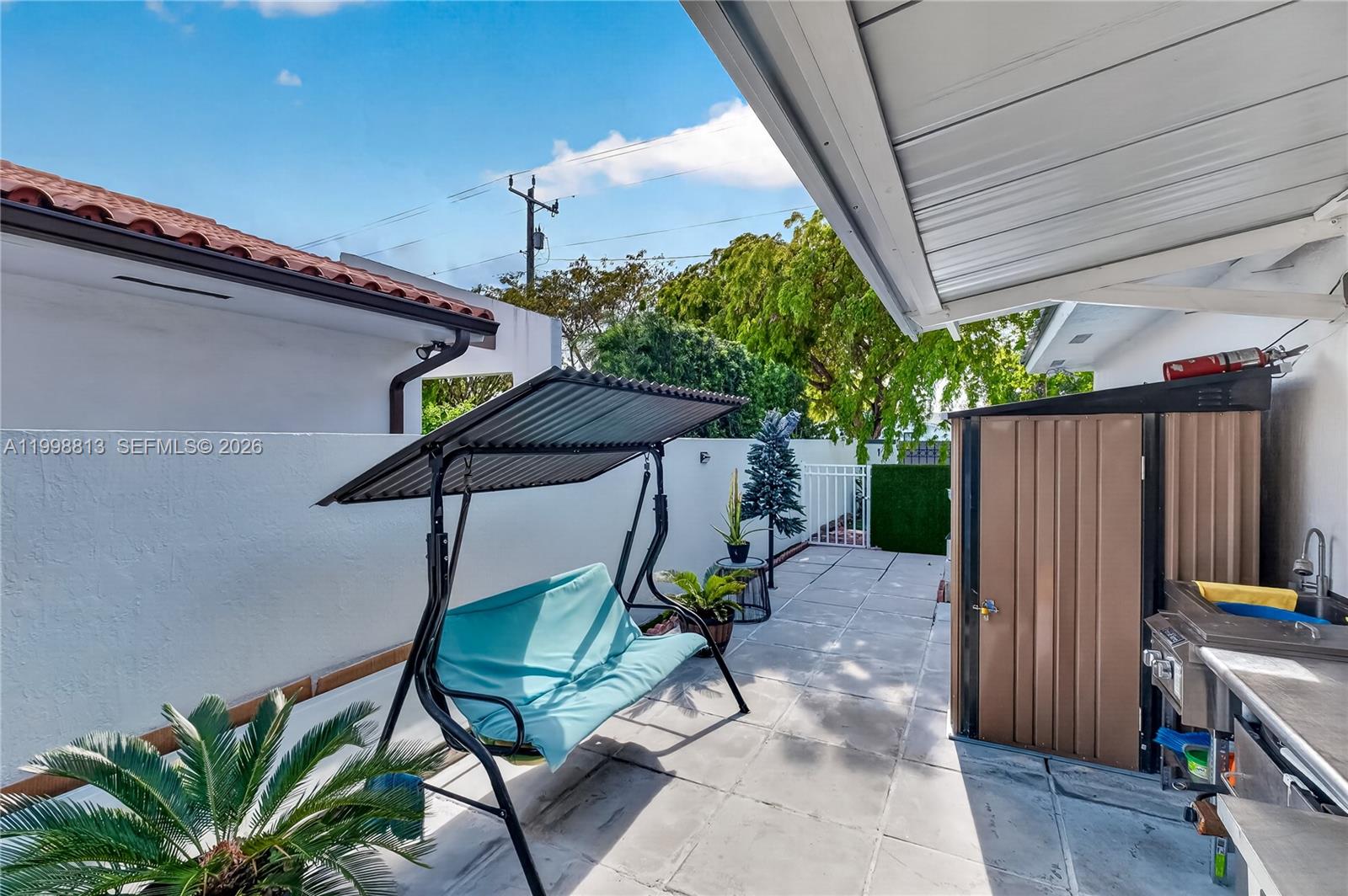 10140 Southwest 26th Terrace Miami, FL 33165 - Photo 61 of 70 a backyard of a house with table and chairs
