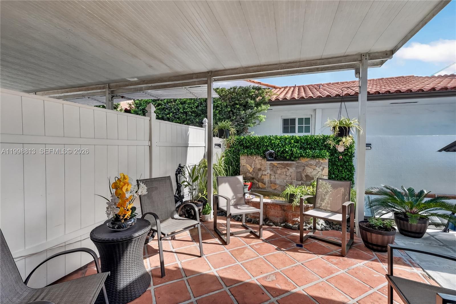 10140 Southwest 26th Terrace Miami, FL 33165 - Photo 66 of 70 a view of a patio with table and chairs potted plants