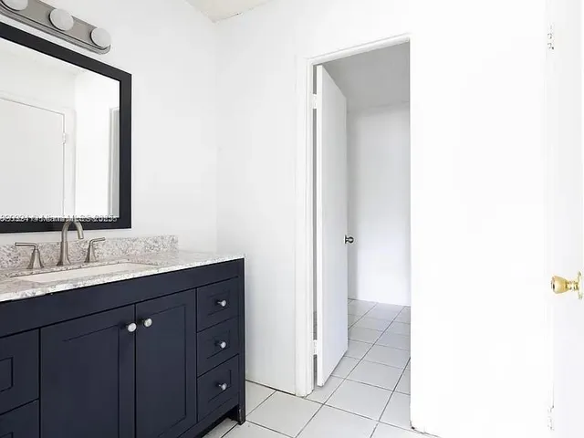 a bathroom with a double vanity sink and mirror