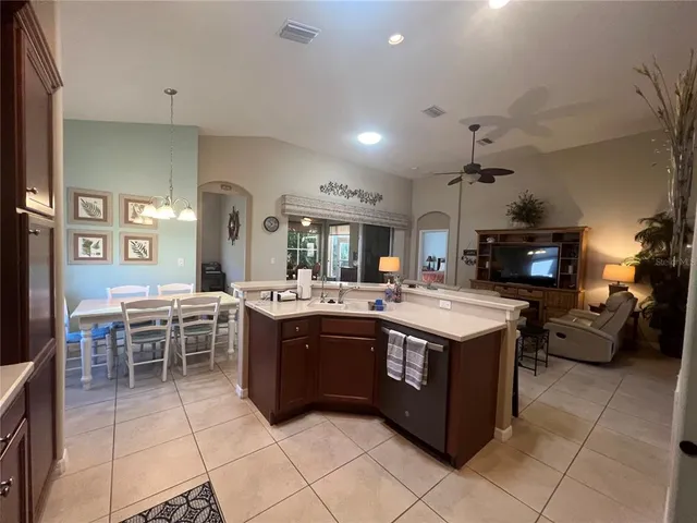 a large kitchen with kitchen island a sink a counter space and stainless steel appliances