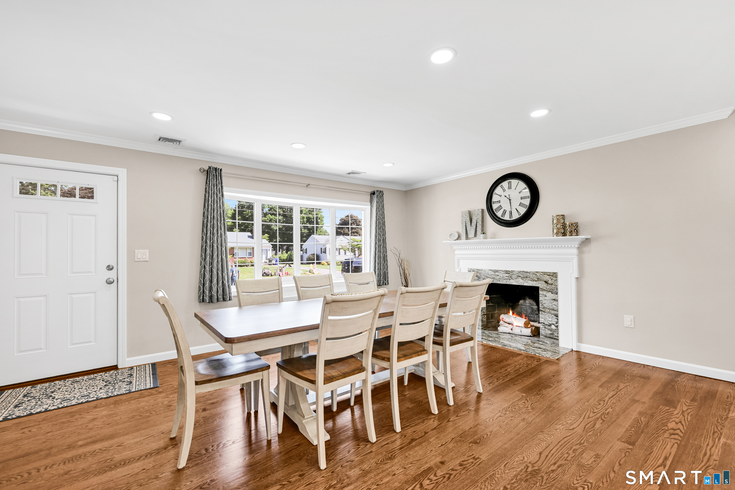 87 Lydall Road Newington, CT 06111 - Photo 13 of 35 a dining room with furniture wooden floor and a fireplace