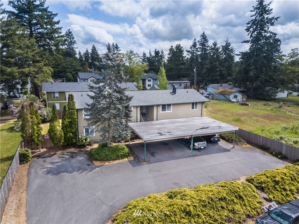3901 Mason Loop Road, Unit AD Tacoma, WA 98409 - Photo 1 of 20 a view of a house with pool and chairs