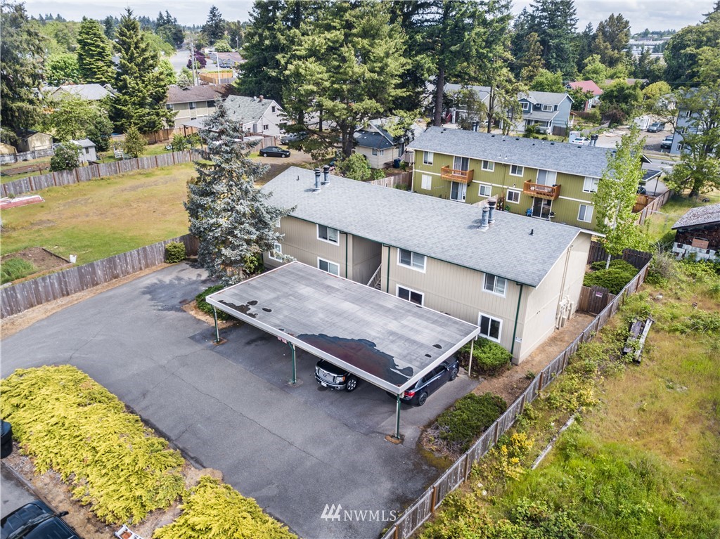 3901 Mason Loop Road, Unit AD Tacoma, WA 98409 - Photo 2 of 20 an aerial view of a house with swimming pool and ocean view