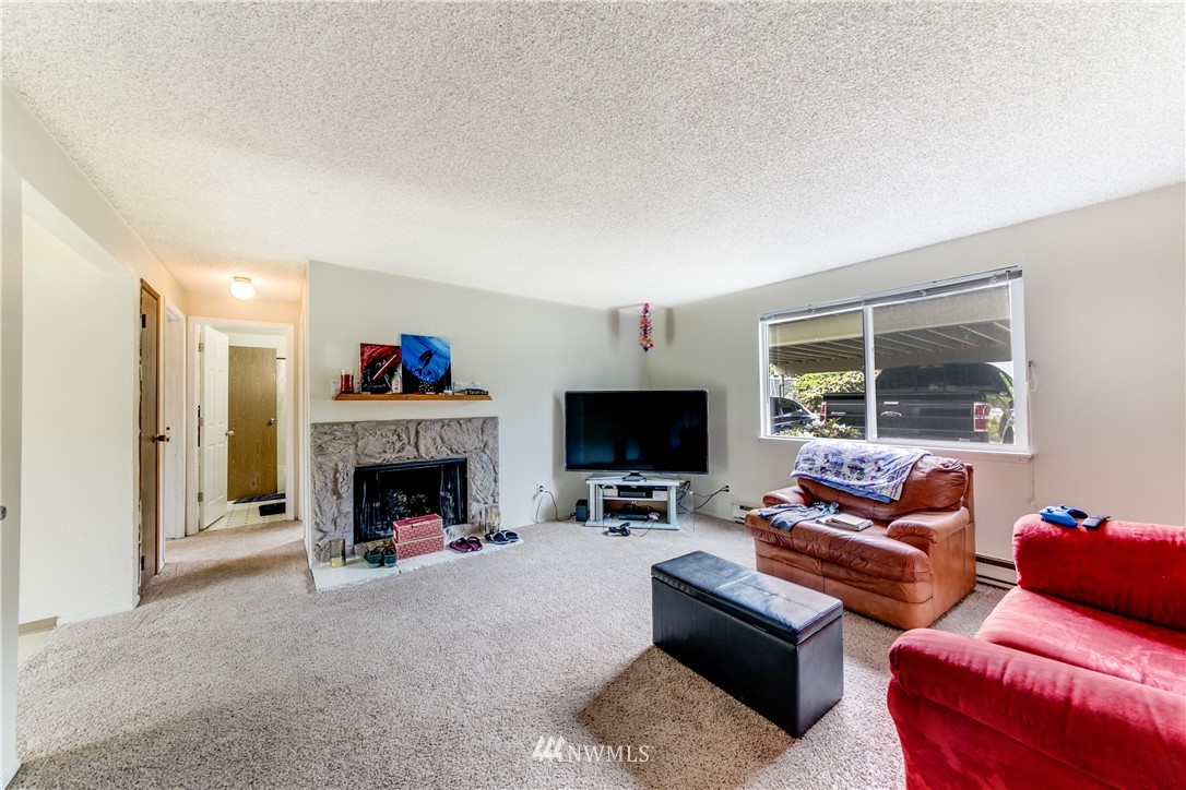 3901 Mason Loop Road, Unit AD Tacoma, WA 98409 - Photo 12 of 20 a living room with furniture and a fireplace