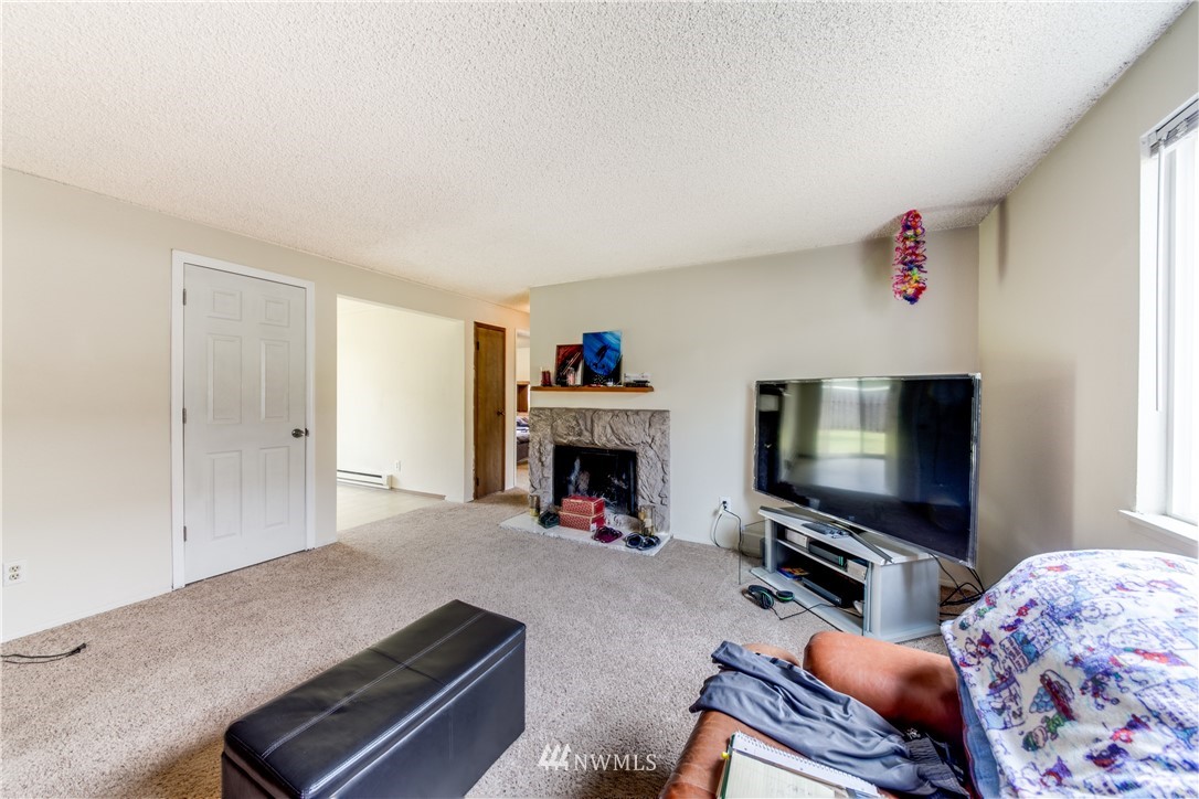 3901 Mason Loop Road, Unit AD Tacoma, WA 98409 - Photo 13 of 20 a living room with furniture and a flat screen tv