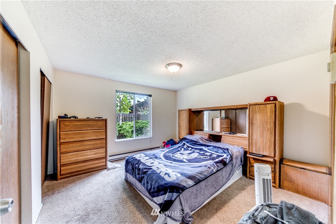 3901 Mason Loop Road, Unit AD Tacoma, WA 98409 - Photo 14 of 20 a bedroom with a bed and a dresser