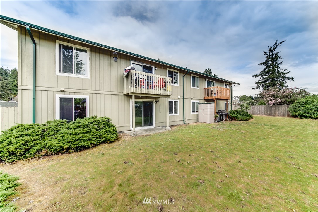 3901 Mason Loop Road, Unit AD Tacoma, WA 98409 - Photo 18 of 20 a front view of a house with garden