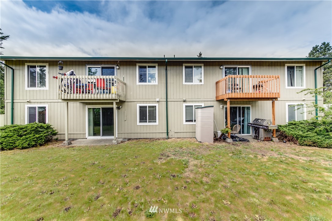 3901 Mason Loop Road, Unit AD Tacoma, WA 98409 - Photo 19 of 20 a front view of a building with many windows