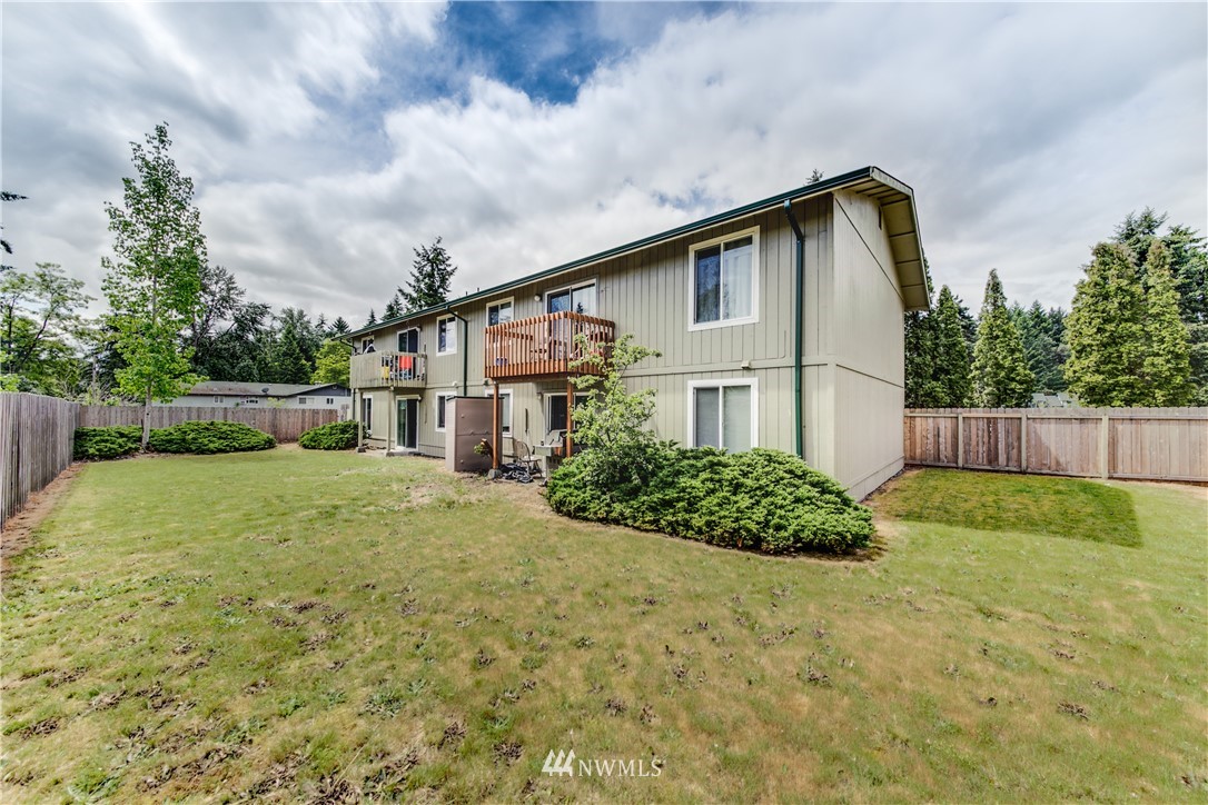 3901 Mason Loop Road, Unit AD Tacoma, WA 98409 - Photo 20 of 20 a backyard of a house with lots of green space