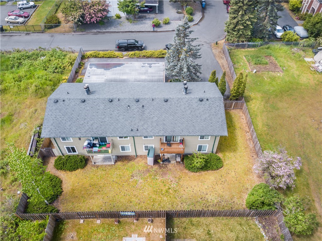 3901 Mason Loop Road, Unit AD Tacoma, WA 98409 - Photo 4 of 20 an aerial view of a house with swimming pool and large trees