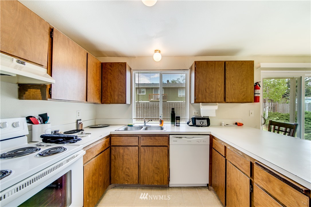 3901 Mason Loop Road, Unit AD Tacoma, WA 98409 - Photo 7 of 20 a kitchen with a sink stove and cabinets