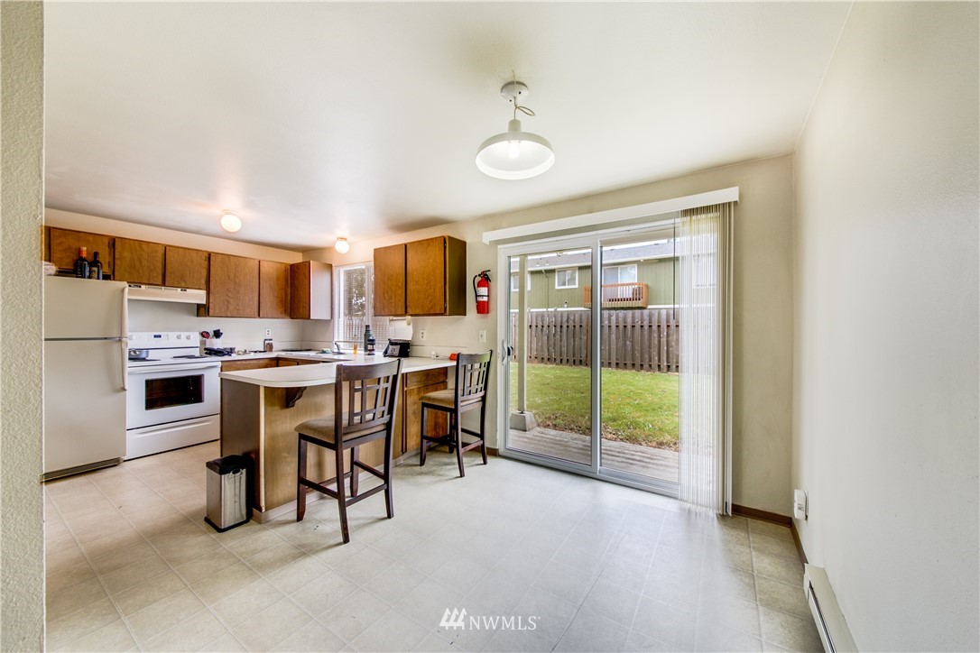 3901 Mason Loop Road, Unit AD Tacoma, WA 98409 - Photo 10 of 20 a open kitchen with granite countertop a sink and white cabinets