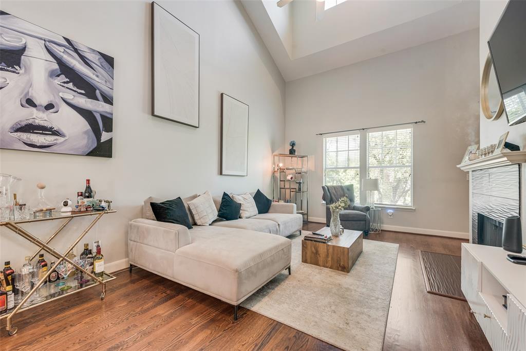 4904 Live Oak Street, Unit 302 Dallas, TX 75206 - Photo 1 of 25 a living room with furniture and a flat screen tv