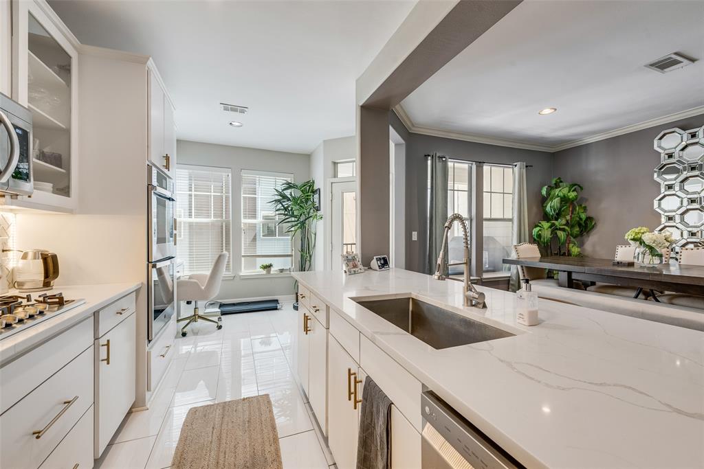 4904 Live Oak Street, Unit 302 Dallas, TX 75206 - Photo 11 of 25 a kitchen with a sink stove and cabinets