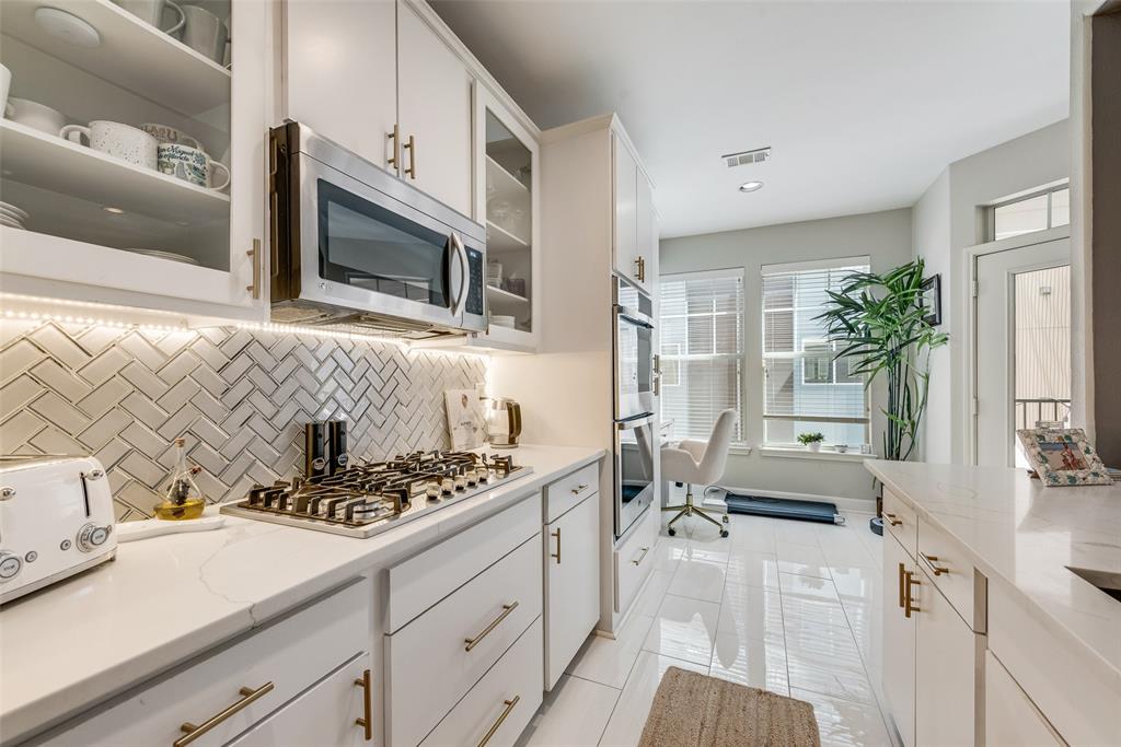 4904 Live Oak Street, Unit 302 Dallas, TX 75206 - Photo 12 of 25 a kitchen with stainless steel appliances a sink a stove and cabinets