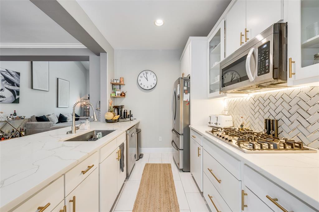 4904 Live Oak Street, Unit 302 Dallas, TX 75206 - Photo 14 of 25 a kitchen with stainless steel appliances granite countertop a sink stove and refrigerator
