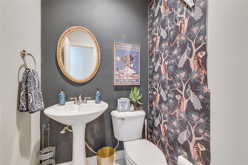 4904 Live Oak Street, Unit 302 Dallas, TX 75206 - Photo 16 of 25 a bathroom with a toilet sink and mirror