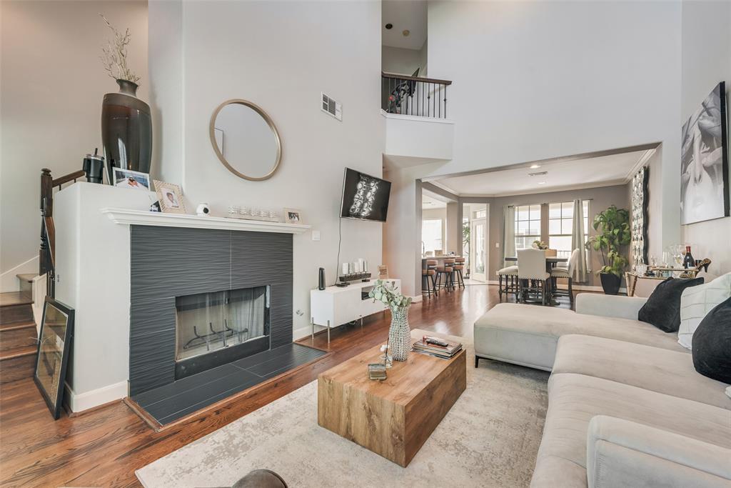 4904 Live Oak Street, Unit 302 Dallas, TX 75206 - Photo 6 of 25 a living room with furniture a fireplace a clock and a large window