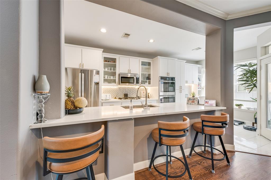 4904 Live Oak Street, Unit 302 Dallas, TX 75206 - Photo 9 of 25 a kitchen with stainless steel appliances kitchen island granite countertop a sink and cabinets