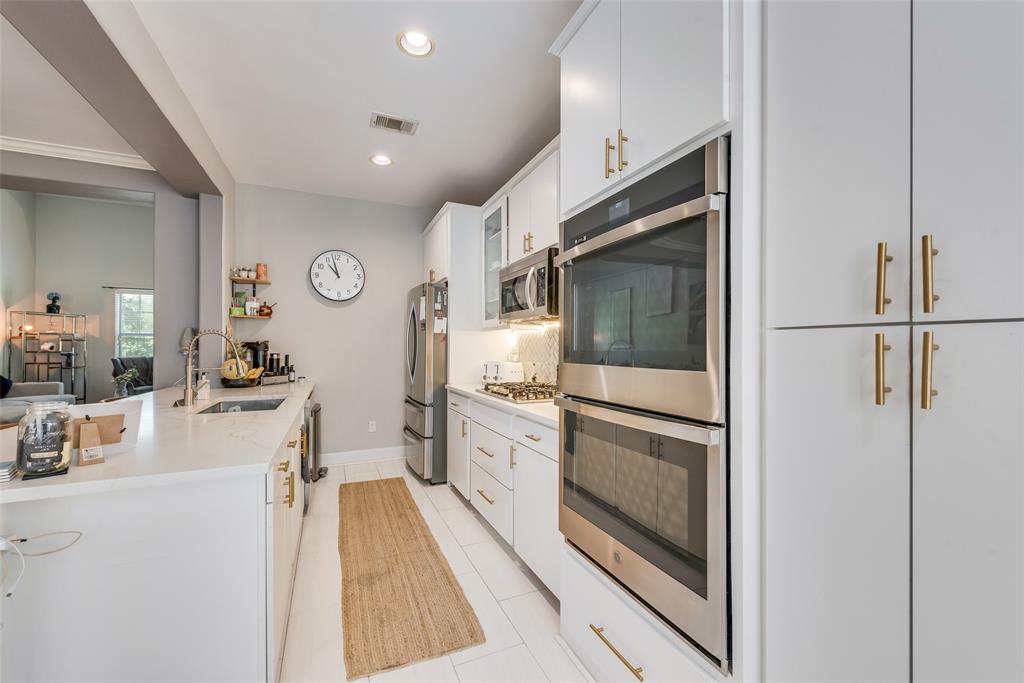 4904 Live Oak Street, Unit 302 Dallas, TX 75206 - Photo 10 of 25 a kitchen with cabinets and stainless steel appliances