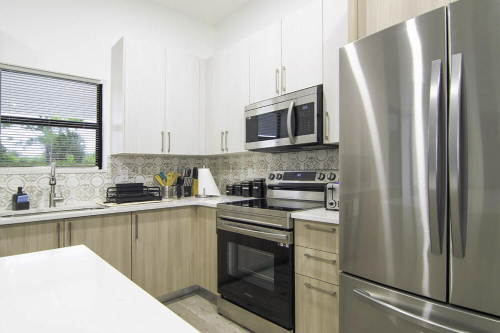 15245 Brainbridge Circle Port Charlotte, FL 33981 - Photo 11 of 52 a kitchen with stainless steel appliances a refrigerator stove and sink