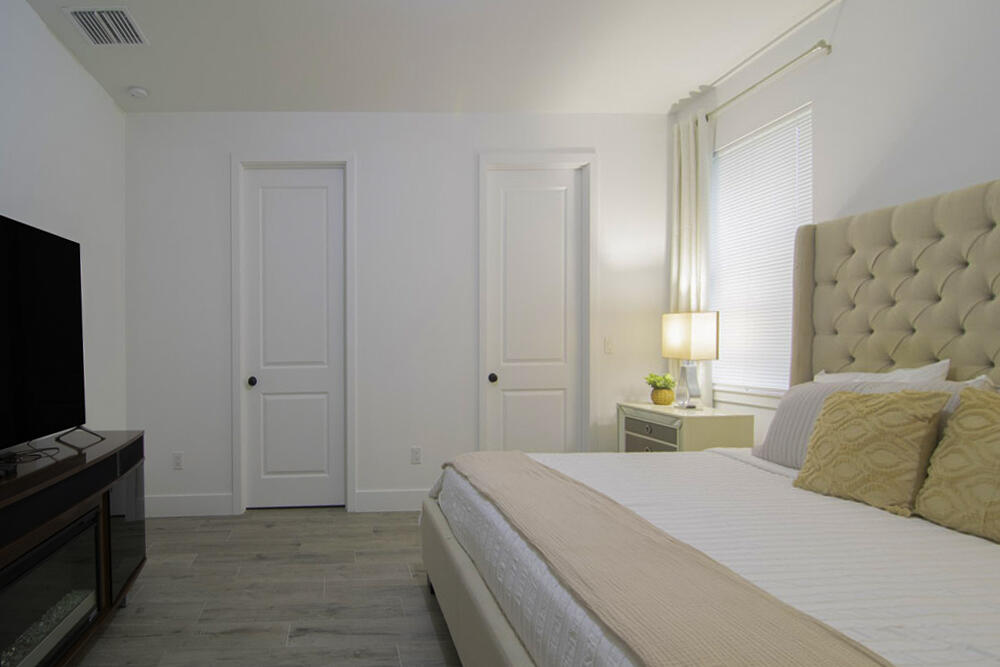 15245 Brainbridge Circle Port Charlotte, FL 33981 - Photo 13 of 52 a spacious bedroom with a bed and a flat screen tv