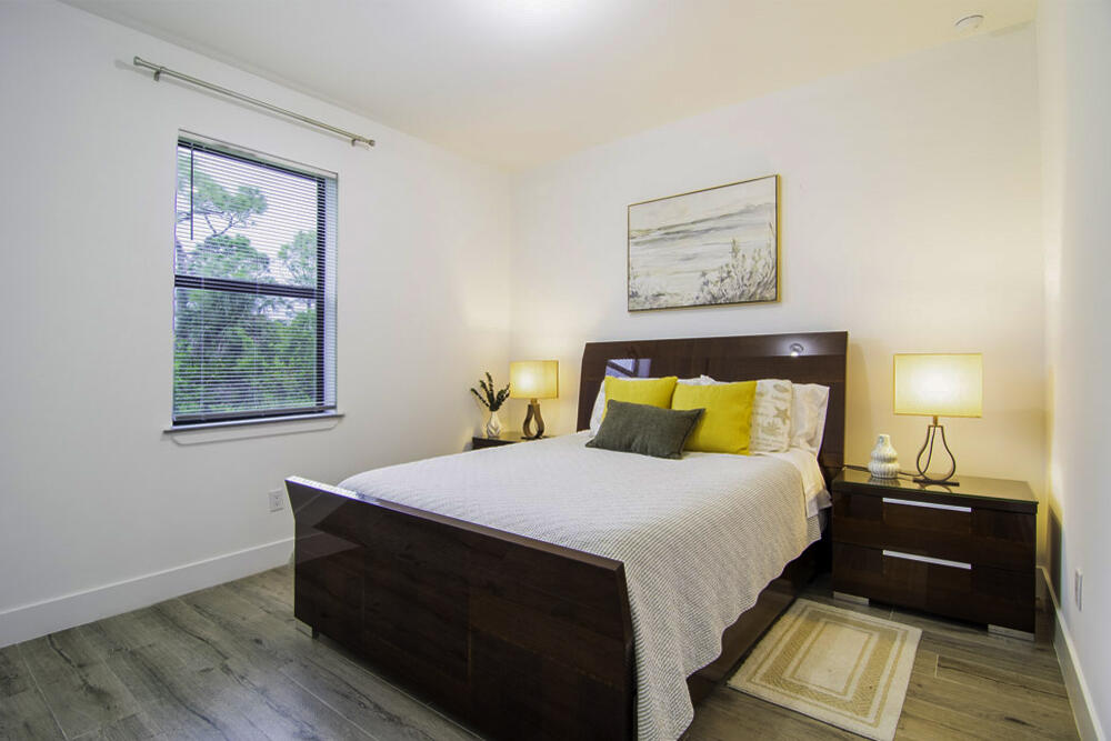 15245 Brainbridge Circle Port Charlotte, FL 33981 - Photo 19 of 52 a room with a bed and a lamp on dresser