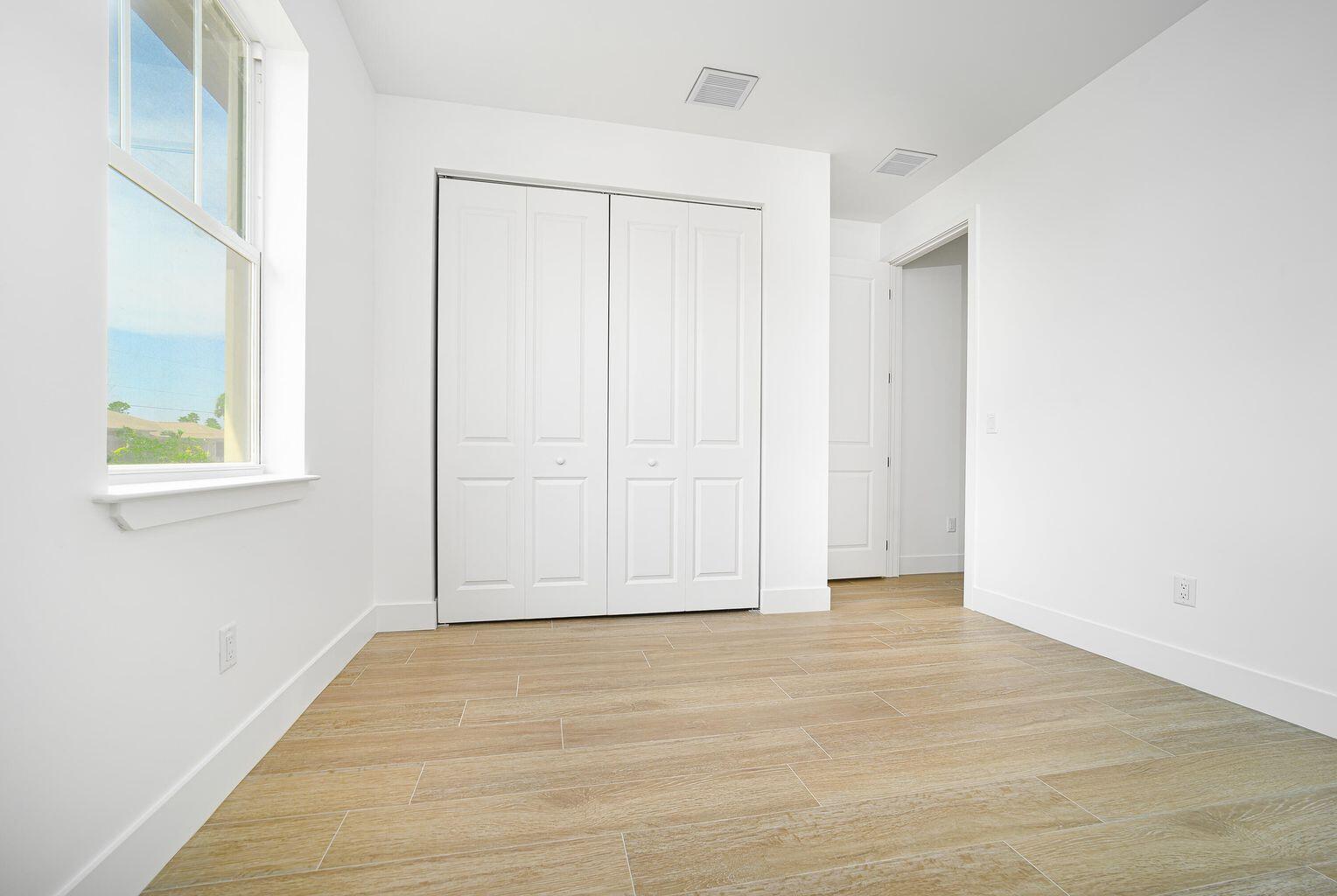 15245 Brainbridge Circle Port Charlotte, FL 33981 - Photo 29 of 52 a view of an empty room with wooden floor