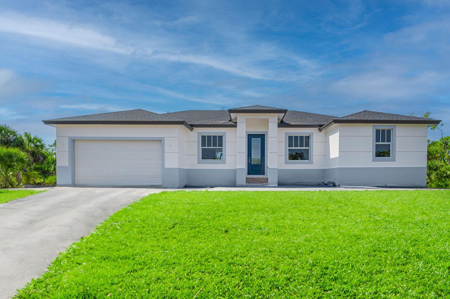 15245 Brainbridge Circle Port Charlotte, FL 33981 - Photo 3 of 52 a front view of a house with a yard and garage