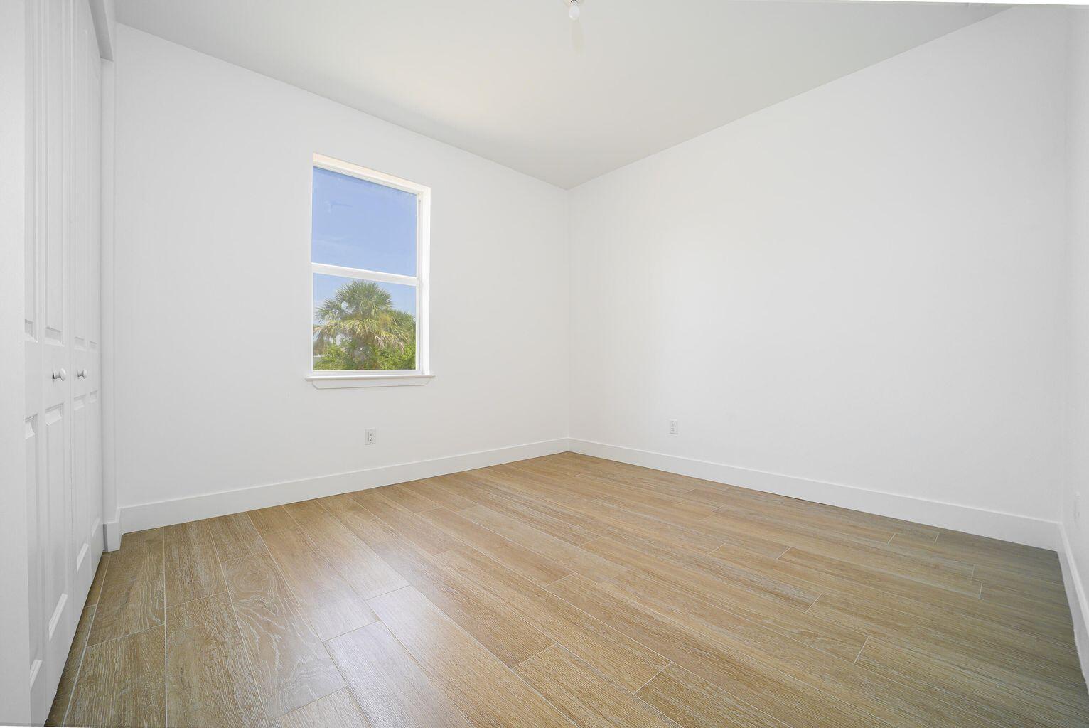 15245 Brainbridge Circle Port Charlotte, FL 33981 - Photo 34 of 52 an empty room with wooden floor and window