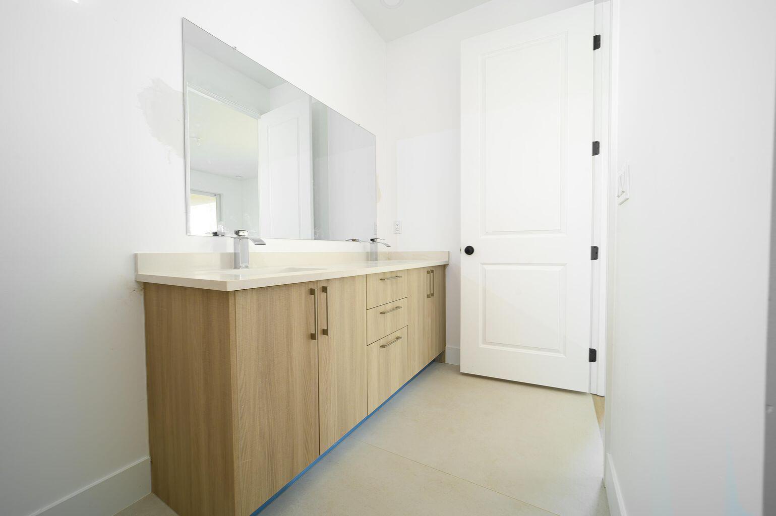 15245 Brainbridge Circle Port Charlotte, FL 33981 - Photo 38 of 52 a bathroom with a double vanity sink and mirror