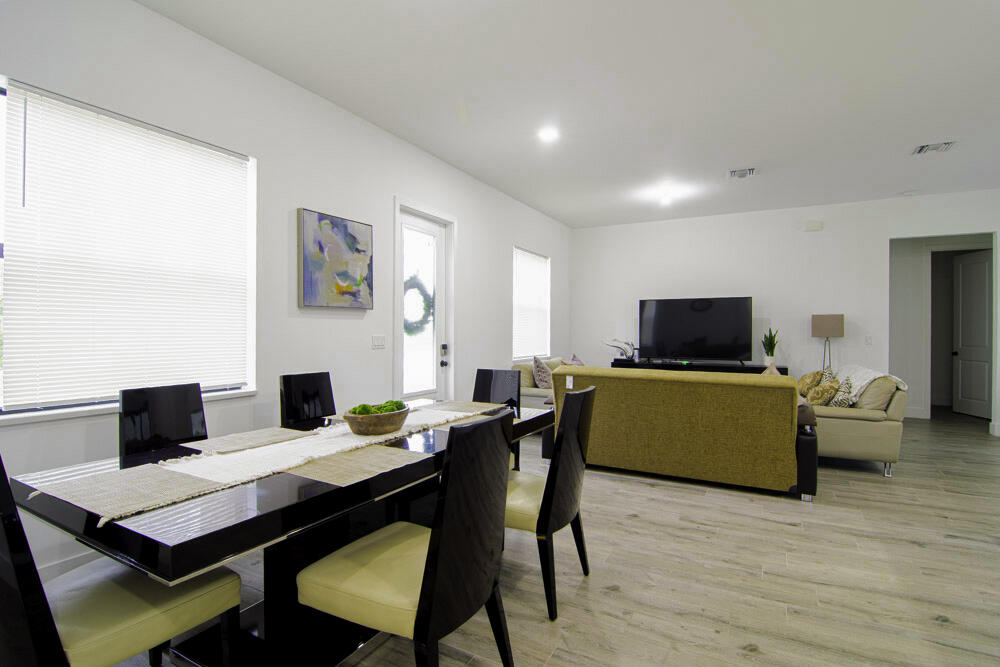 15245 Brainbridge Circle Port Charlotte, FL 33981 - Photo 6 of 52 a view of a dining room with furniture and wooden floor