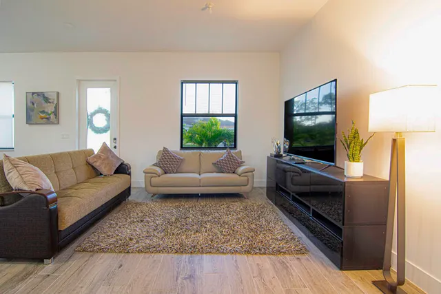 a kitchen with stainless steel appliances kitchen island granite countertop a stove a sink and a refrigerator