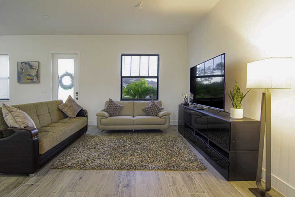 15245 Brainbridge Circle Port Charlotte, FL 33981 - Photo 8 of 52 a living room with furniture and a flat screen tv