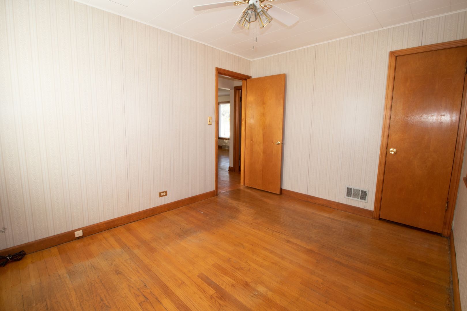 215 Iroquois Road Hillside, IL 60162 - Photo 14 of 26 an empty room with a chandelier fan