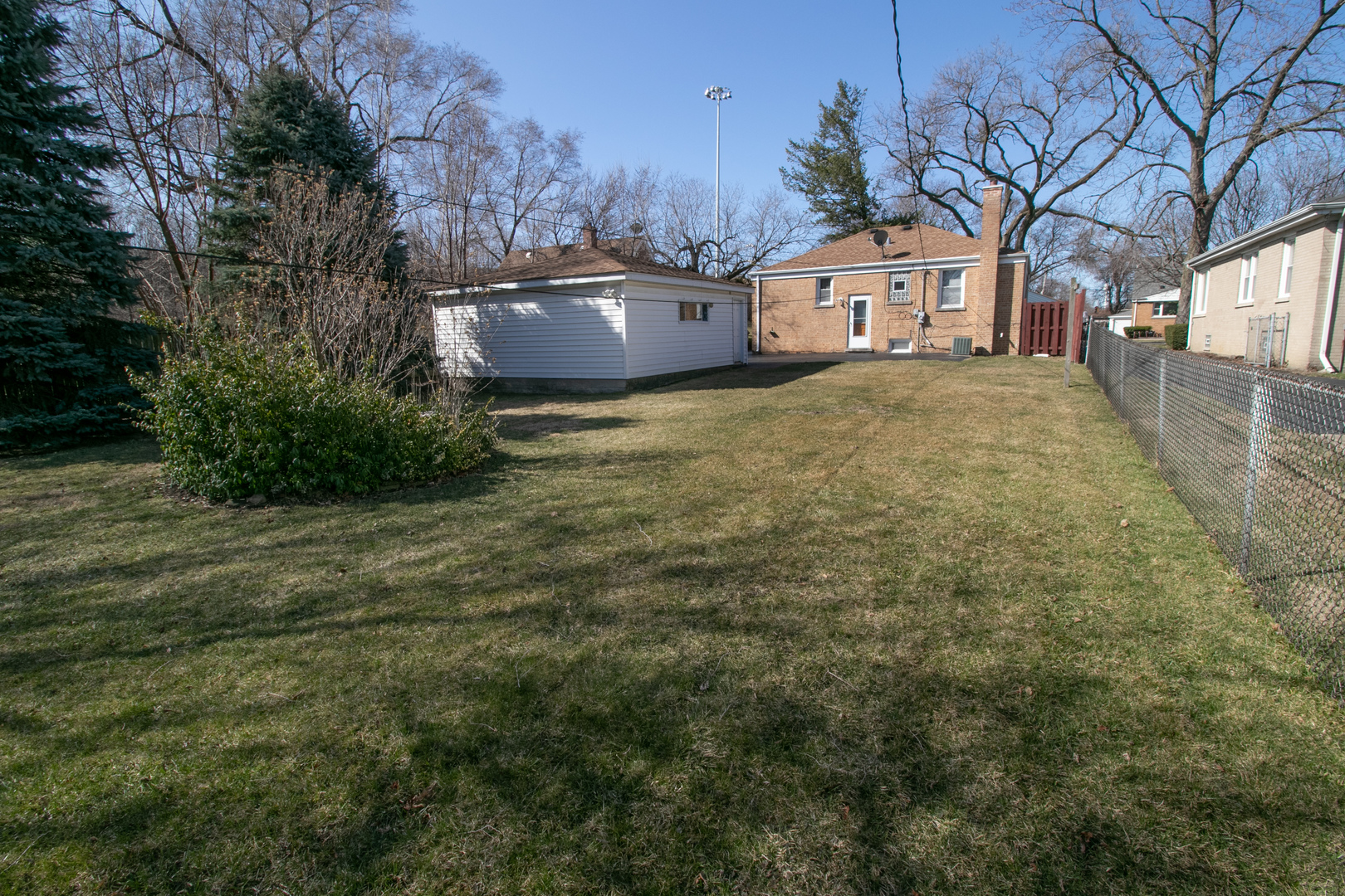 215 Iroquois Road Hillside, IL 60162 - Photo 23 of 26 a front view of a house with a yard and large tree
