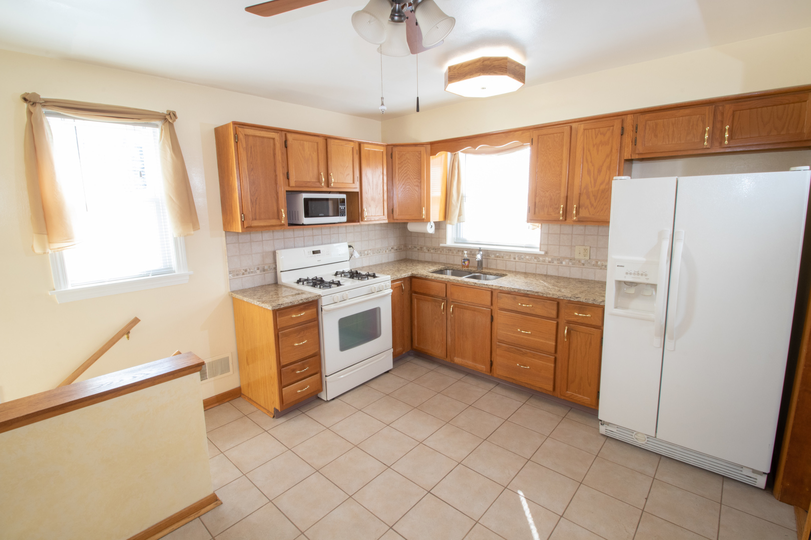 215 Iroquois Road Hillside, IL 60162 - Photo 6 of 26 a kitchen with a stove sink and a refrigerator